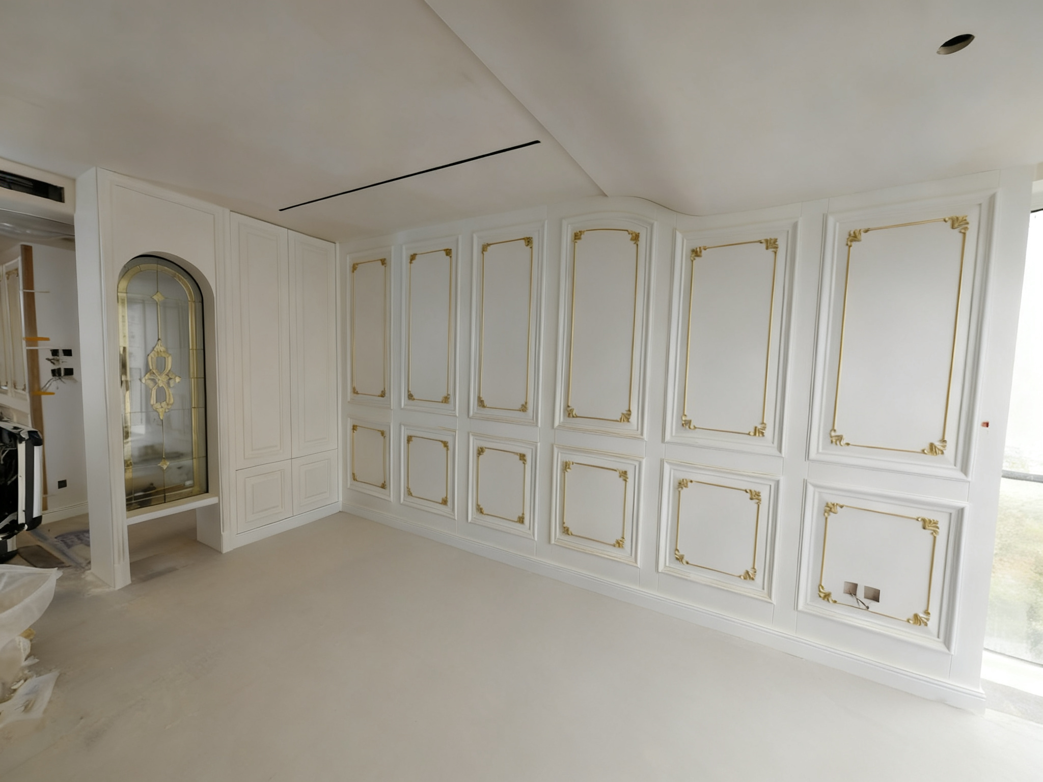 Bedroom: white wall paneling with gold trim and cabinets