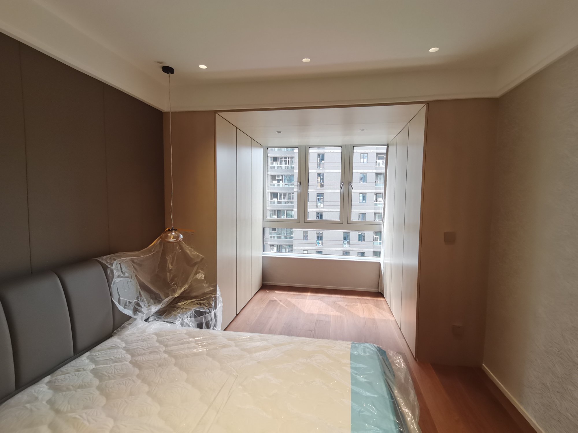 Bedroom custom wardrobes on both sides of bay window