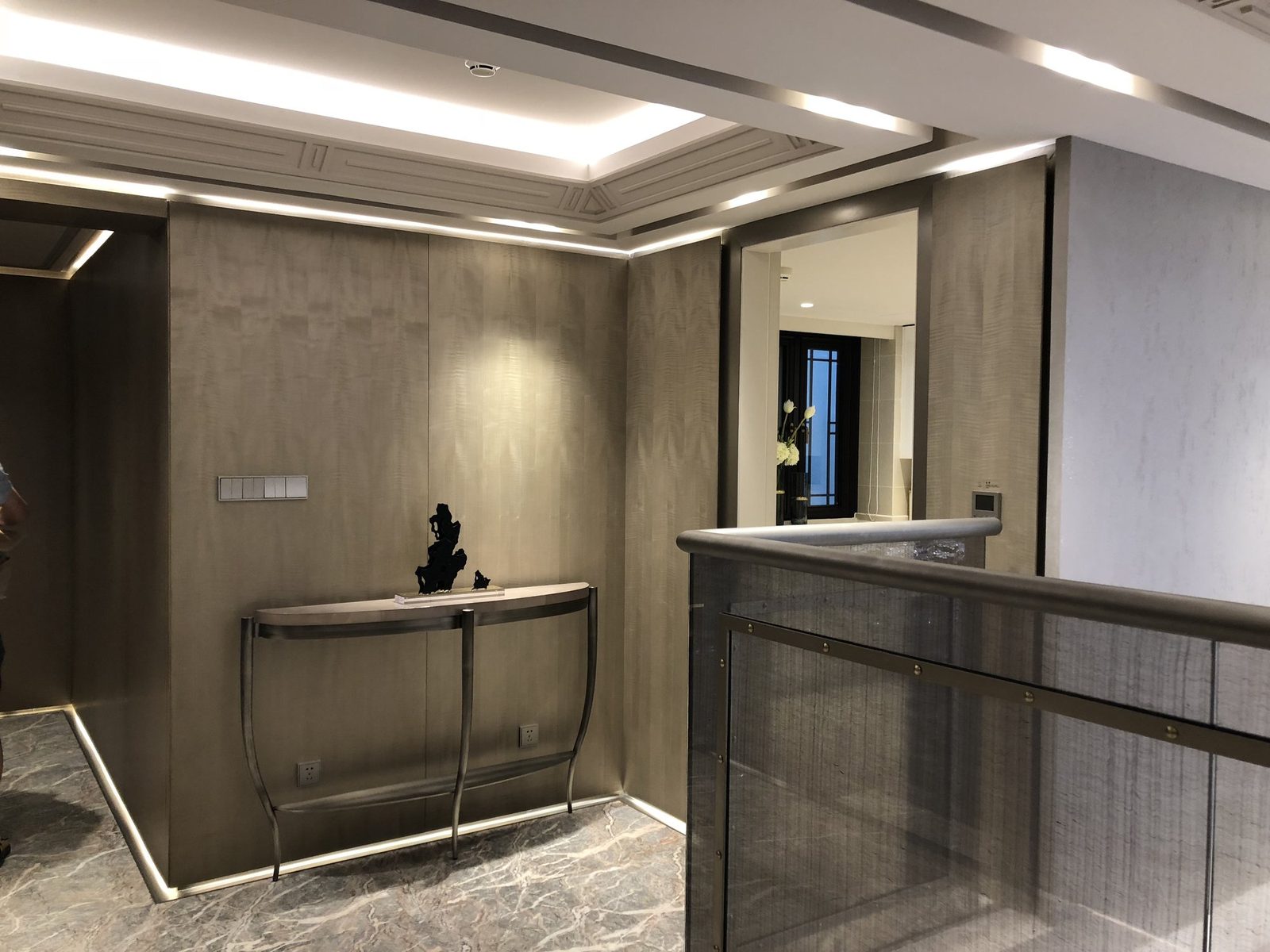 Entry custom wood veneer wall paneling.