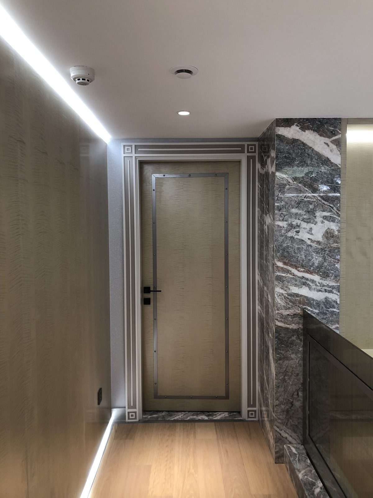 Entry custom interior door with metal trim and frame.