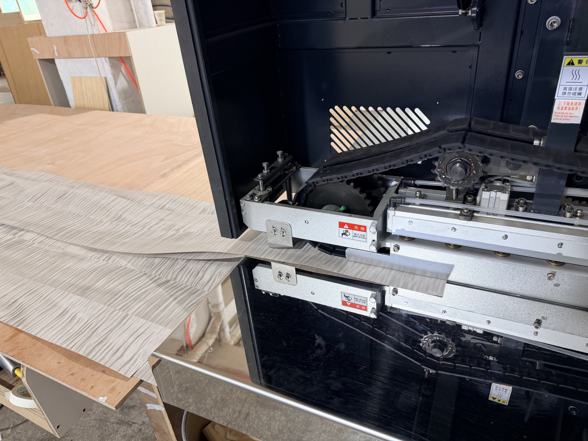 Close-up of veneer splicing machine in operation