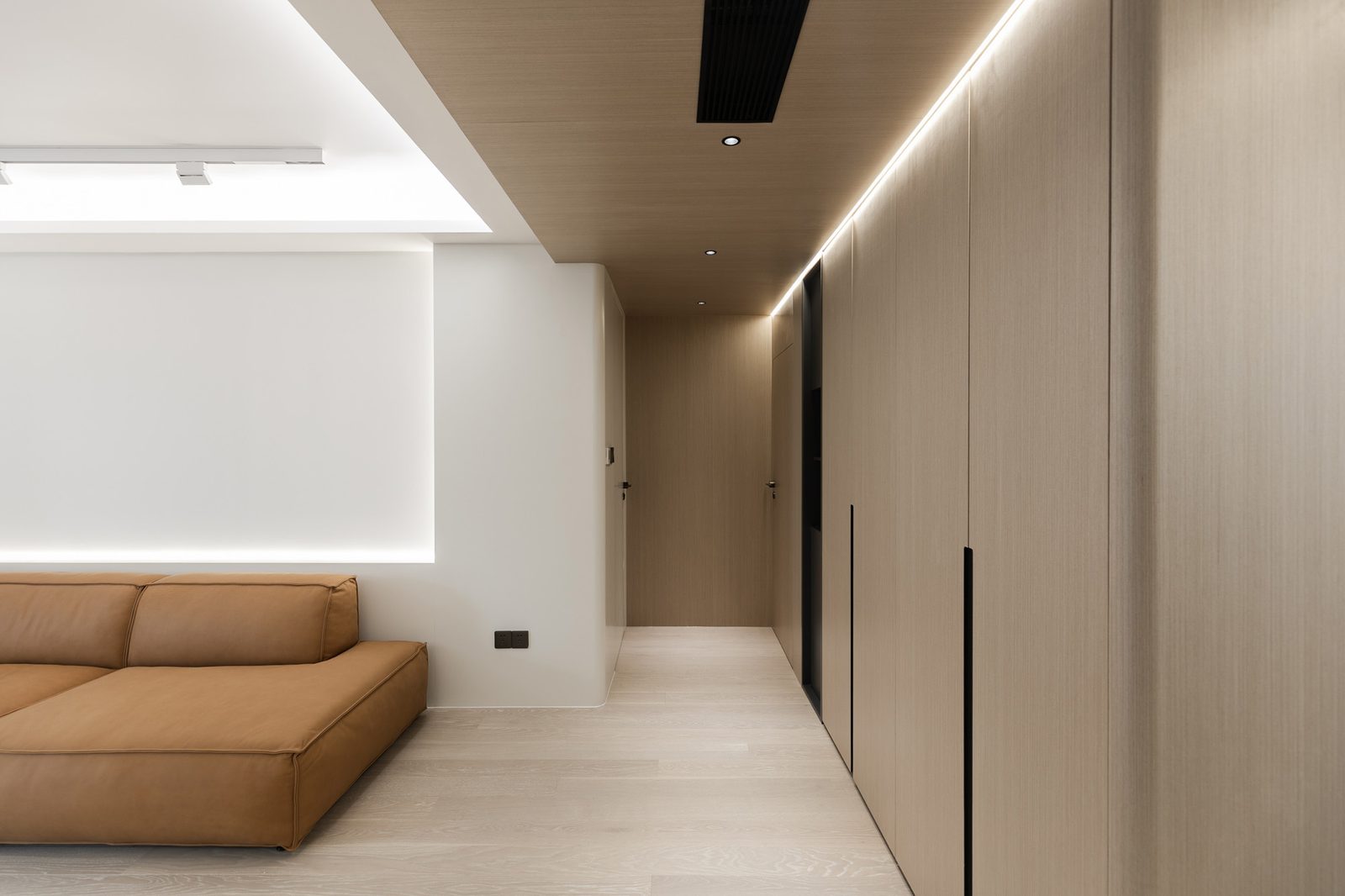 Living room full-wall custom cabinetry with matching wall panels