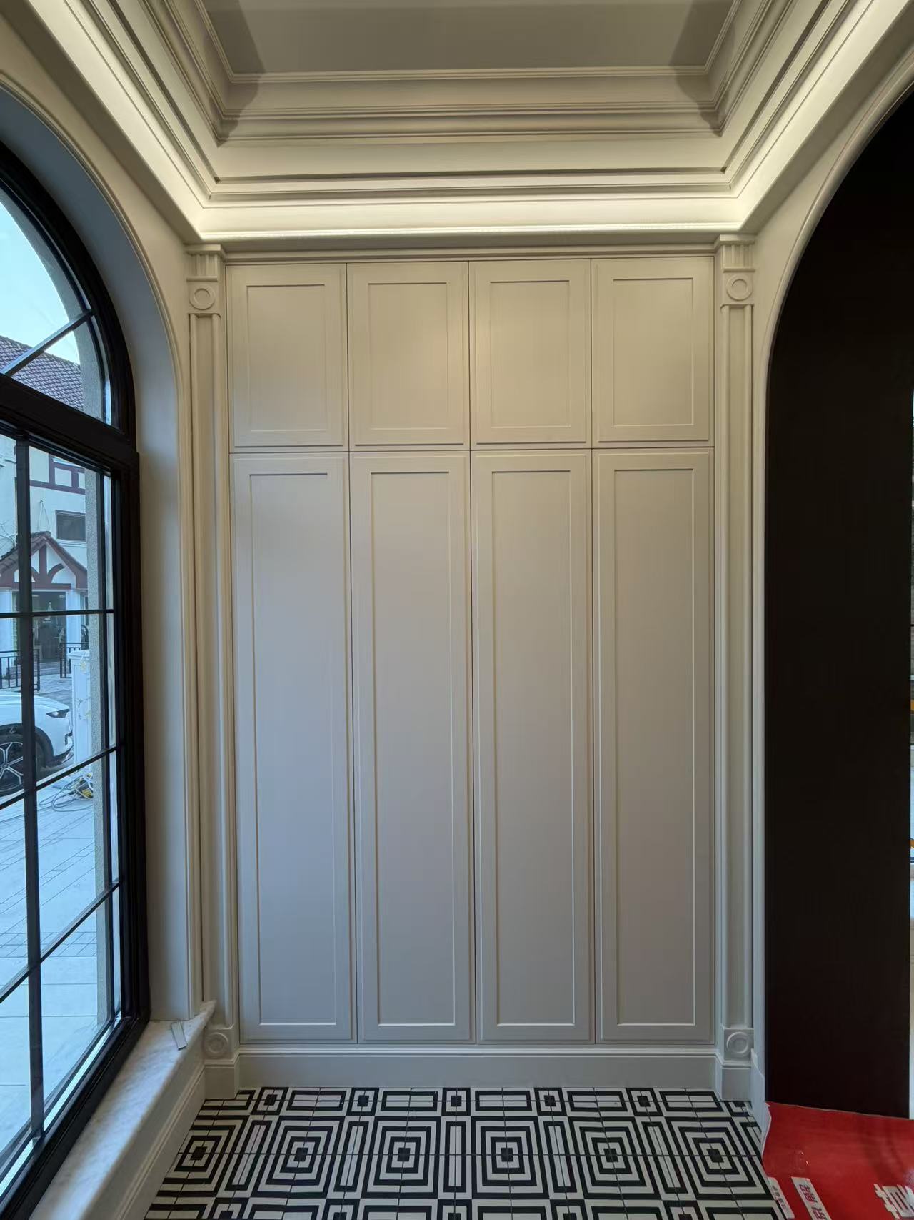 Entryway with column-style full-height custom cabinetry