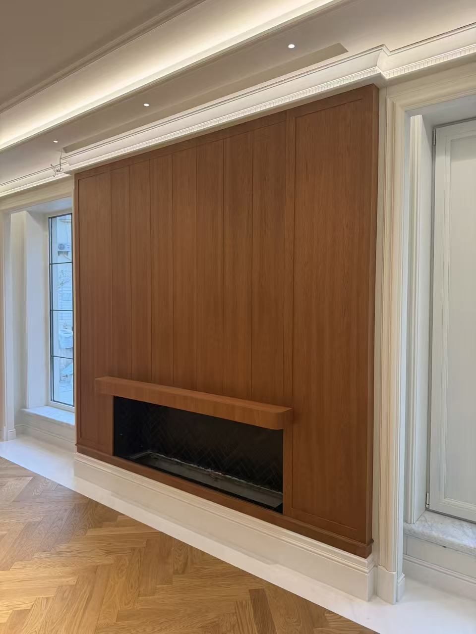 Living room with built-in fireplace and wood wall paneling