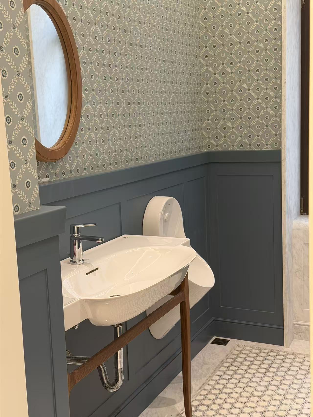 Bathroom with dark gray wall paneling and washbasin
