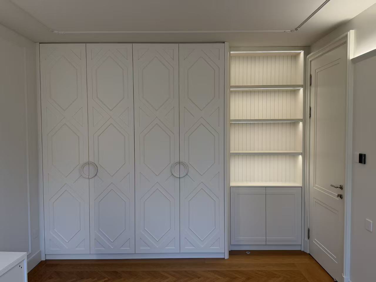 Bedroom with geometric-pattern wardrobes and storage cabinet