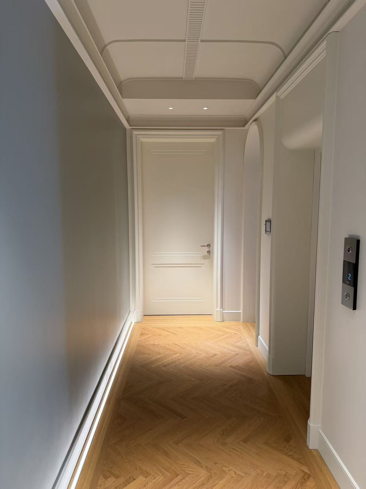 Corridor with interior door and wall paneling lines