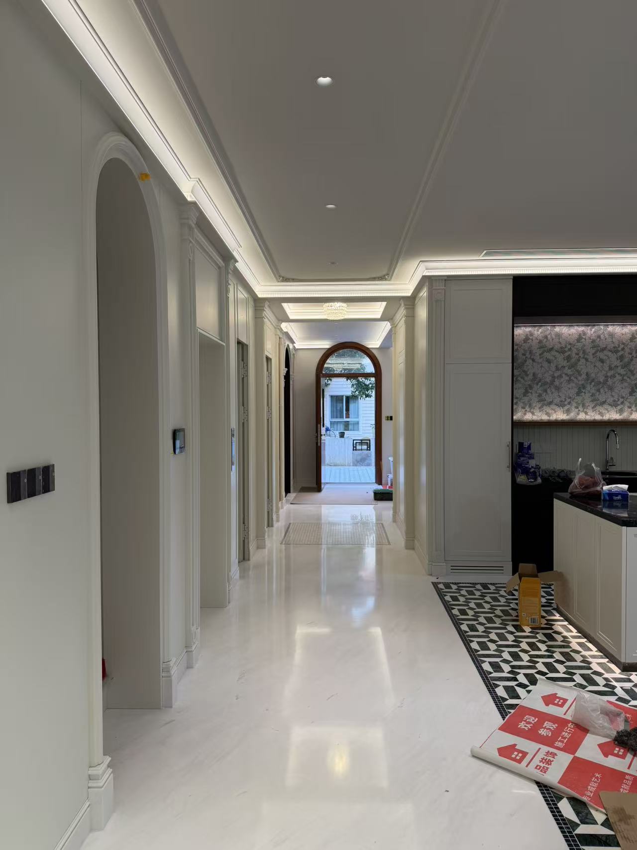 Entryway with wall paneling and arched door casing