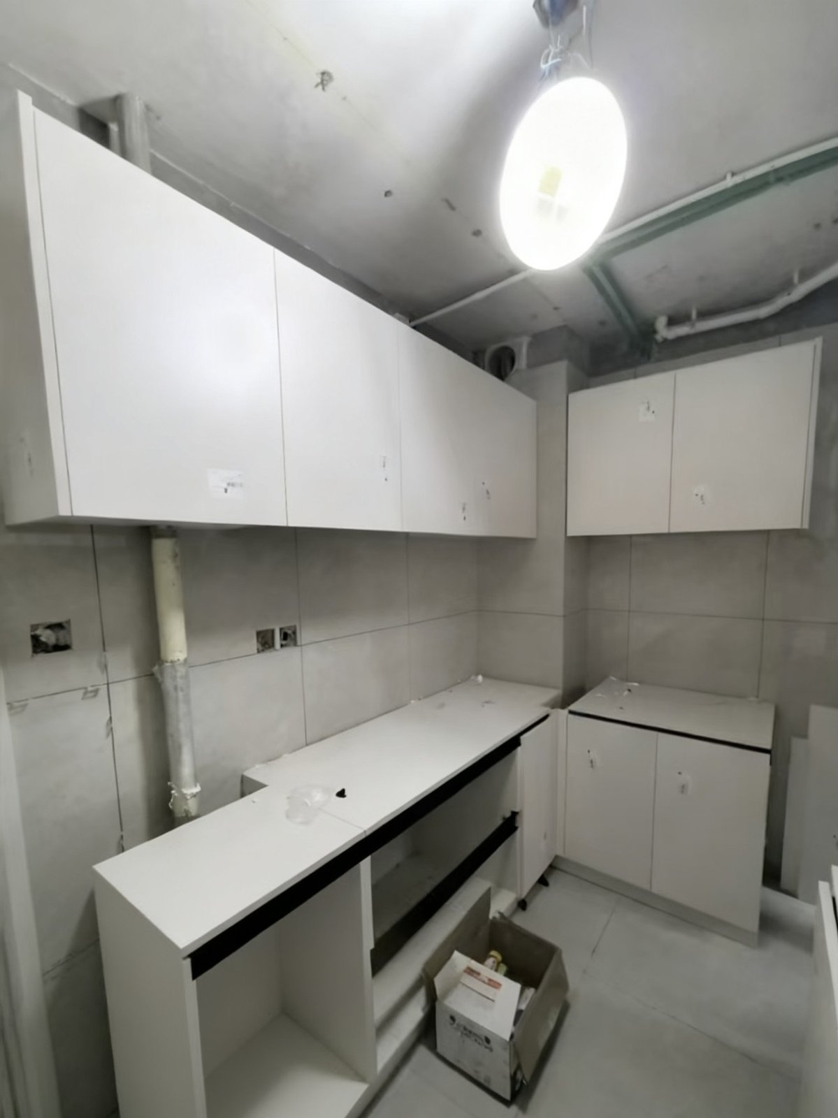 Kitchen: white custom cabinet units awaiting completion